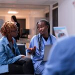 Nurse speaking to a patient in a waiting room.